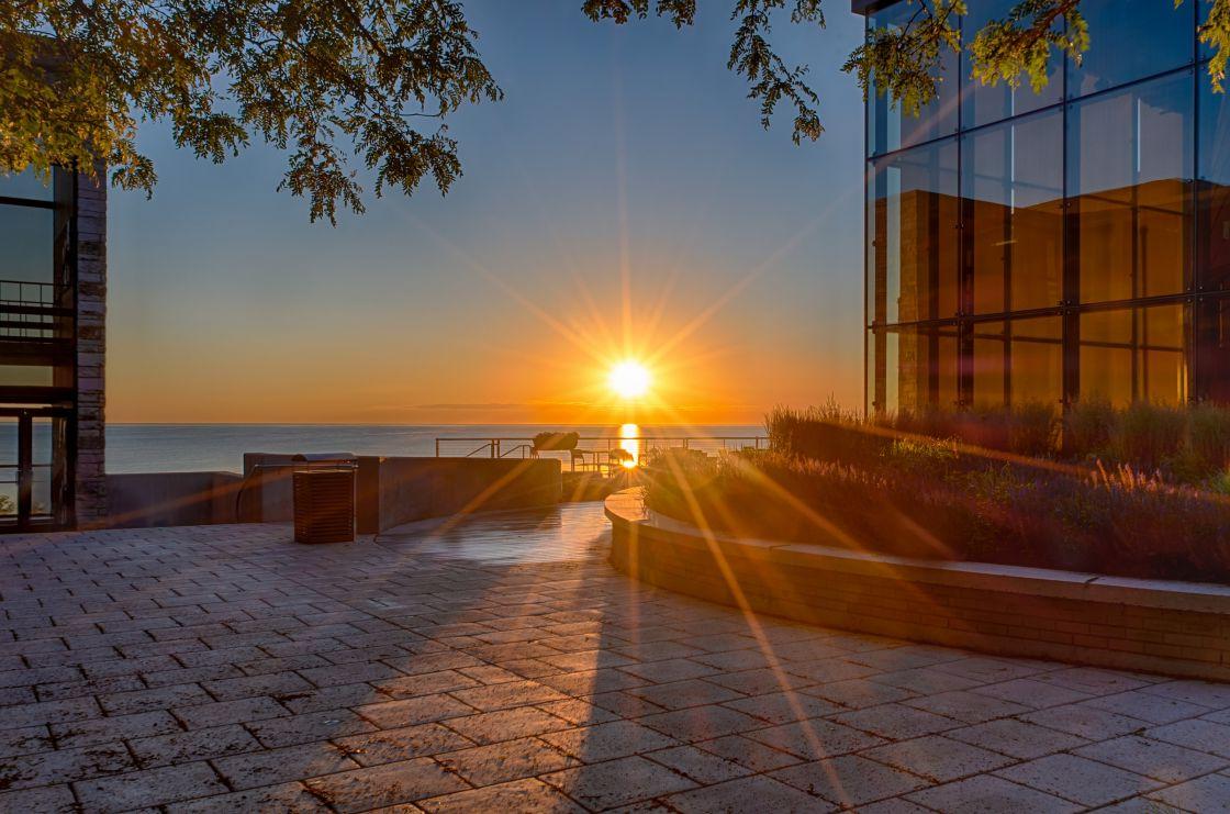 The sun's rays begin to wake up the Carthage College campus near the Hamar Patio near the Science...